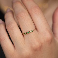 A stacking ring with genuine green tsavorite garnet in 14K solid gold. A dainty 3 stone ring for women with natural gemstones.  100% handcrafted with love! * Material: 14K solid white gold, 14K yellow gold * Gemstone: Tsavorite, round cut * Gemstone's Weight: 0.06 ct HOW TO ORDER * Choose from the drop-down menus the available options (Ring size, Material) and leave us a note for any special requirements. PRODUCTION TIME - SHIPPING POLICIES * Please keep in mind that each item is handcrafted, and we need 5 days at least for its production. If you need your order on a specific date, please contact us. * All orders are shipped worldwide via FedEx Express for speed and security. The estimated delivery time is 3 days to the US and Europe and 5 days to anywhere else. * All our pieces are delive Tsavorite Garnet Ring, 3 Stone Ring, Daily Wear Jewellery, Tsavorite Garnet, 3 Stone Rings, Green Garnet, Stackable Bands, Garnet Ring, Pretty Earrings