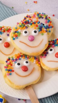 some cookies with frosting and sprinkles are on a plate