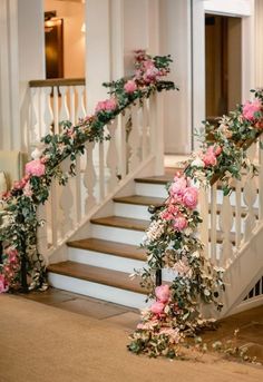 flowers and greenery decorate the banisters at this wedding