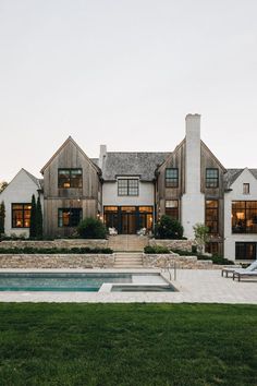 a large house with a pool in front of it