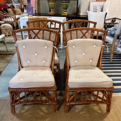 two chairs sitting next to each other on top of a carpeted floor in a store