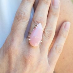 Feminine, vibrant and substantial, this one-of-a-kind ring checks all the boxes for a beautiful, modern statement. The considerable pink opal is prong-set onto a sterling silver double band, giving you maximum comfort and security. The tear drop shape of the stone will elongate your hand and add just the right amount of elegance. This opal is 1 1/4" long by 5/8" wide and is set on a double band that is 5/16" from top to bottom. All Haley Lebeuf One-of-a-Kind pieces are imagined first in the page Modern Pink Teardrop Jewelry, Double Band Ring, Double Band Rings, Pink Opal, Tear Drop, Band Ring, Prong Setting, Band Rings, Opal