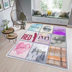 a living room area with a large rug on the floor and pictures hanging above it