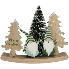 two gnomes are standing next to each other in front of a small christmas tree