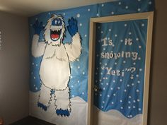 a room decorated in blue and white with an image of a bigfoot on the wall