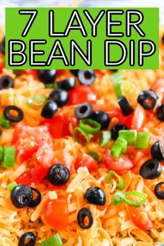 the 7 layer bean dip is loaded with black olives, tomatoes, peppers and cheese