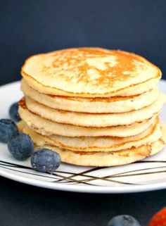 a stack of pancakes with blueberries on a plate