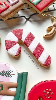 decorated cookies and cookie cutters sitting on top of a table