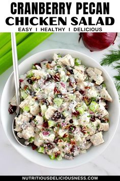 a white bowl filled with chicken salad next to celery