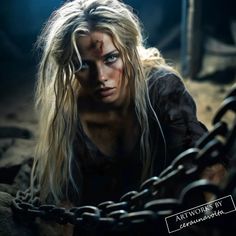 a woman with long blonde hair and blue eyes is chained to a large metal chain