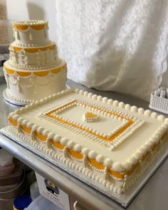 two tiered cake sitting on top of a table