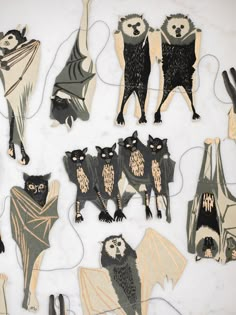 some cut out animals and bats on a table