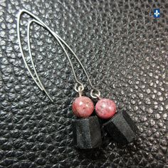 Charming Rhodonite & Black Rough Tourmaline - Plated Silver Earrings ⚜ Length: 2 1/2 inches ⚜ Weight (ea.): 3.8 g ⚜ Stainless Steel Hooks ⚜ As any natural stone, these stones could have some  minor flaws . ⚜  Pictures taken under profesionnal studio lights.  As if they were pictured outside under the blue sky of a sunny day.  According to your monitor settings, colors may slightly vary. The Craftsman Advantage with BijouxQuebec: You don't like the clasp of a bracelet? The hooks of a pair of earrings don't suit you? You find a necklace too long? Not long enough? No problem at all! Spot in my shop what you would have preferred and if possible, I will make the change for you, most of the time quite free. Cluster Pendant, Lovely Necklace, Mesh Bag, Star Charms, Black Pearl, Pendant Earrings, Initial Necklace, Natural Stone, Tourmaline