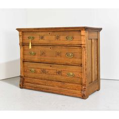 an old wooden dresser sitting on top of a white floor