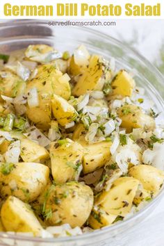 a glass bowl filled with potatoes and onions