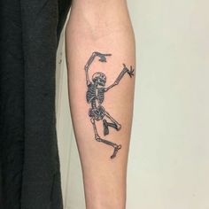 a man with a skeleton tattoo on his arm