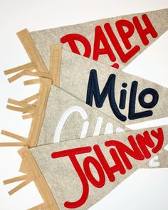 three pennants with the words dapp, milo, and johnny written on them