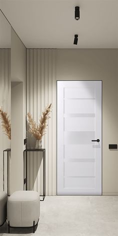 an empty room with a white door and two stools in front of the door