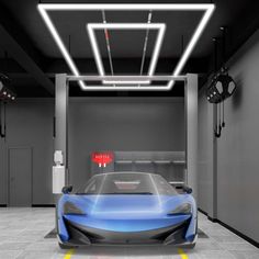 a blue sports car is parked in a garage with lights on the ceiling and overhead lighting