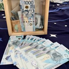 some money is sitting in a wooden box