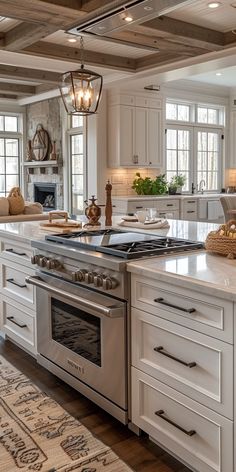 a kitchen with white cabinets and an island