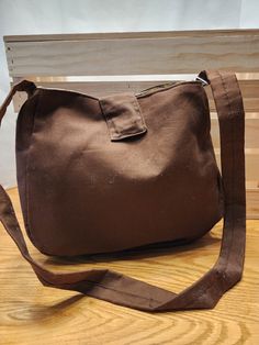 This is a simple shoulder bag with plenty of pockets inside for easy access storage.  Magnetic closure and the shoulder strap is 36" long.  Machine washable, broadcloth exterior and quilters cotton lining. Brown Canvas Shoulder Bag With Pockets, Brown Cotton Hobo Bag With Large Capacity, Large Capacity Cotton Hobo Bag In Brown, Fabric Shoulder Bag With Adjustable Strap, Brown Canvas Hobo Bag With Pockets, Brown Cotton Shoulder Bag For Everyday Use, Fabric Shoulder Bag With Zipper Pocket For Daily Use, Fabric Shoulder Bag With Pockets For Travel, Large Capacity Brown Fabric Shoulder Bag