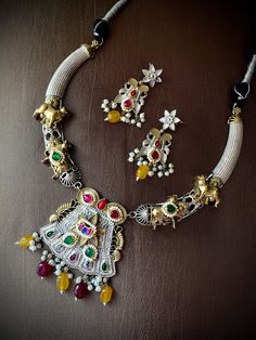 Another beautifully crafted ethnic fusion concept gold Nandi, colored bead drops, semi precious stones studded 92.5 silver coated hasli necklace for upcoming festivities. Trendy necklace set to gleam your festive appearance. Comes with matching earrings. Brass is used as base metal. Style this with any Ethnic or Indo Western Attire. ✅Shop our collection here: https://www.etsy.com/shop/KKsCulture 💕Send us an email if you need help! ✅ Contact Us: +1 (732) 325-2222 Hasli Necklace, Necklace Set Gold, Necklace Indian, Trendy Necklace, Gold Necklace Set, Silver Coat, Jewelry Statement, Trendy Necklaces, Stone Studs