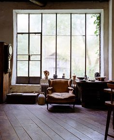 an old fashioned living room with large windows