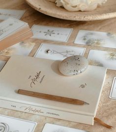 a table topped with lots of white flowers and cards