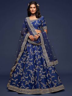 An uncut sapphire, deep blue ocean and the midnight sky, all leave us mesmerised. Leave people stunned in our luxe silk lehenga set. Crafted in fine silk with zari work, embroidery and sequins sown into it, make this piece timeless and moody. The set consists of a beautiful choli with 3/4th sleeves that has delicate lace work done around its neck and at the end of the sleeves. A lehenga that has been embellished, along with a dainty net dupatta. Fabric- Art Silk 3/4th sleeves Round Neck Lehenga Lehenga Choli Designs, Lehenga Design, Lengha Choli, Blue Lehenga, Net Lehenga, Fancy Wedding, Saree Design, Ghagra Choli, Party Wear Lehenga