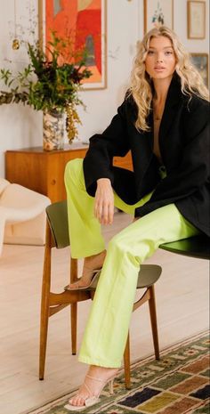 a woman sitting on top of a wooden chair