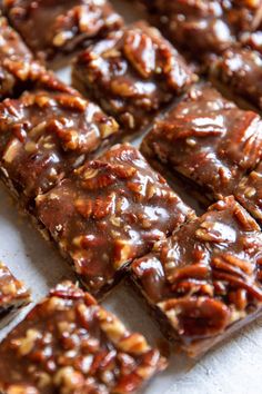 chocolate pecan bars are cut into squares and stacked on top of each other, ready to be eaten