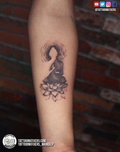 a woman's arm with a tattoo on it and a lotus flower in the center