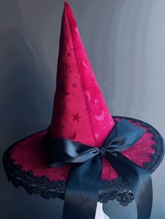 eElevate your mystical allure with our Celestial Enchantress Witch Hat, adorned with a captivating celestial pattern of stars and moons. Available in deep crimson, pristine white, or classic black velvet, each hat is finished with elegant black lace and a satin ribbon, making it a stellar choice for any magical gathering or Halloween festivity. Size/Type: One size fits most Hat Colors: Deep Crimson, White, Black Hat Material: Velvet fabric Accent Material: Black lace and satin ribbon Age Group/G Mardi Gras Kid, Kids Party Packs, Celestial Pattern, Ribbon Making, Stars And Moons, Type One, Masquerade Mask, Couple Halloween, Black Hat