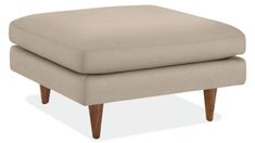 the footstool is upholstered with wood legs and an ottoman that sits on top of it