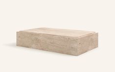 a stone box sitting on top of a white surface