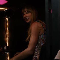 a woman standing in front of a mirror smiling