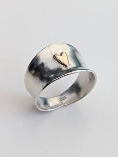 I love this! It is pretty cool and because of the shape of the ring it's very comfortable to wear. The top is 15mm wide with a 9ct Gold Heart on and the underside is 4mm so it's not a problem to close a fist. Beautifully shaped and lightly dappled sterling silver. These are made to order so in any size but the hearts are hand drawn and cut so may differ slightly. Please let me know a ring size when ordering and allow for making time. Etsy Silver Rings, Stacked Silver Rings, Gold Rings Chunky, Vintage Silver Ring, Silver And Gold Ring, Heart Shaped Ring, Ring Inspo Jewelry, Heart Rings, Cool Accessories