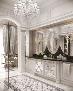 an elegant bathroom with chandelier and marble counter tops, white walls and flooring