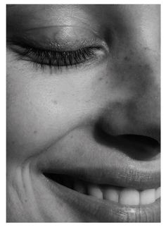 black and white photograph of a woman's face smiling