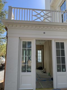 an open door leading into a white house