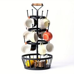 a rack with cups and saucers hanging from it's sides in front of a white background