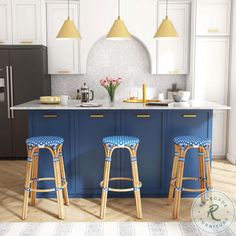 two stools in front of a kitchen island with blue countertops and white cabinets