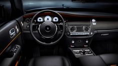 the interior of a car with black leather and orange trim