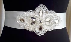 "This delicate silver crystal sash is truly stunning and would add the perfect finishing touch to create a romantic vintage vibe. Studded with high quality silver crystal navettes and embroidered with silver bugle beads this belt sparkles, glitters and gleams making it a real classic bridal accessory. The appliqué has been attached to double sided satin ribbon for a really high quality feel. The double sided satin lends its self perfectly to creating a neat bow at the back. You can choose the colour of your ribbon for your sash from picture 6. In our \"bricks and mortar\" shop, this is one of our most popular belts for brides who are looking for a touch of diamanté with a vintage vibe and it's price point makes it a favourite for bridesmaids. Just imagine how pretty the coloured ribbon bow Bridal Accessory, Wedding Sash Belt, Belt Vintage, Ribbon Belt, Beaded Belt, Wedding Belts, Bridal Belt, Bugle Beads, Vintage Vibe