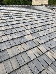 a roof that has been cleaned and is covered in wood shingles, with a chimney on