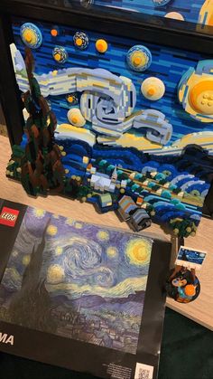 legos are on display in front of the starry night art work that is being displayed