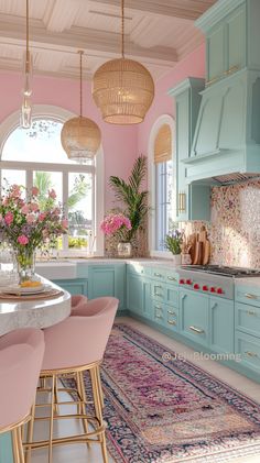 a pink and blue kitchen with lots of counter space in the center, along with an area rug on the floor