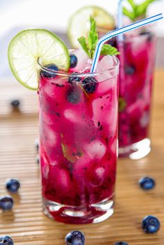 two glasses filled with blueberries and limeade