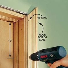 a person using a drill to fix a door